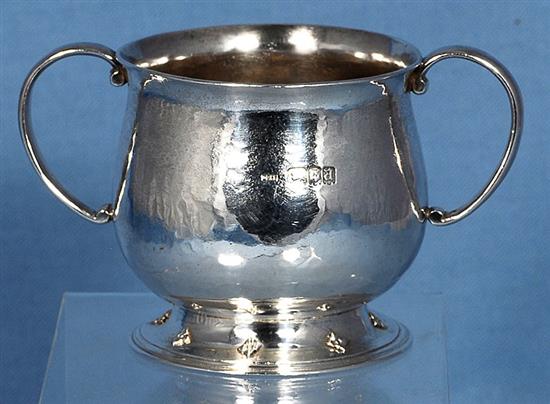 A George V Arts & Crafts silver two handled cup, Width to handles 5”/128mm Height 3”/78mm Weight 7oz/197grms